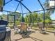 Screened patio with outdoor dining furniture and seating area at 2994 Adrienne Way, The Villages, FL 32163