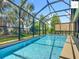 Relaxing screened-in pool with clear blue water and green garden views at 2994 Adrienne Way, The Villages, FL 32163