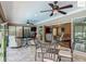 Inviting sunroom with travertine floors, ceiling fans and lots of natural light at 2994 Adrienne Way, The Villages, FL 32163