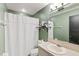 Bathroom with a white shower curtain, toilet, vanity and mirror with accent lighting at 3015 Casselwood St, Winter Park, FL 32792