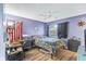 Bedroom featuring a ceiling fan, wood-look flooring, American flag decor, and window with curtains at 3015 Casselwood St, Winter Park, FL 32792