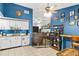 Open kitchen with blue accent wall, white cabinets, and eat-in breakfast nook at 3015 Casselwood St, Winter Park, FL 32792