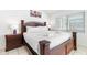 Comfortable bedroom featuring a large bed, nightstands, lamps, and a window with blinds for privacy at 3016 Bloomsbury Dr, Kissimmee, FL 34747