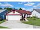 Charming single-story home featuring a well-maintained lawn and attached two-car garage at 3016 Bloomsbury Dr, Kissimmee, FL 34747
