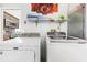 Laundry area equipped with a washing machine and a dryer, adjacent to kitchen at 3016 Bloomsbury Dr, Kissimmee, FL 34747