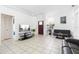 Living room with tile flooring, natural light, and a view of the front door, creating a welcoming ambiance at 3016 Bloomsbury Dr, Kissimmee, FL 34747