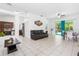 Bright and airy living area featuring tiled floors, a dining area, and seamless access to the screened-in pool at 3016 Bloomsbury Dr, Kissimmee, FL 34747