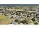 An aerial view of a residential area, showing houses surrounded by lush greenery at 3128 Ibis Hill St, Clermont, FL 34714