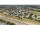 An aerial shot features the real estate nestled amidst an established community, near a busy road at 3128 Ibis Hill St, Clermont, FL 34714