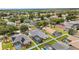 Wide aerial shot capturing a suburban neighborhood with several screen-enclosed pools and fenced yards at 3128 Ibis Hill St, Clermont, FL 34714