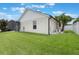 Manicured backyard with a screened enclosure, white fencing, and lush green grass and mature landscaping at 3128 Ibis Hill St, Clermont, FL 34714