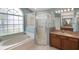Bright bathroom featuring a soaking tub with window, and a walk-in glass shower at 3128 Ibis Hill St, Clermont, FL 34714