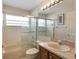 Bathroom featuring tiled tub shower, vanity with a large mirror and vanity lights at 3128 Ibis Hill St, Clermont, FL 34714