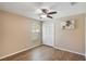 Bedroom featuring wood floors, neutral paint, ceiling fan, window, and closet at 3128 Ibis Hill St, Clermont, FL 34714