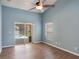Spacious primary bedroom features wood floors, vaulted ceilings, and sliding glass doors to the pool at 3128 Ibis Hill St, Clermont, FL 34714