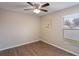 Clean bedroom offering wood flooring, neutral paint, ceiling fan, and a window at 3128 Ibis Hill St, Clermont, FL 34714
