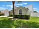 Well-maintained front yard showcasing green lawn, trimmed hedges, and a partial view of the home's facade at 3128 Ibis Hill St, Clermont, FL 34714