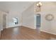 Spacious living room featuring hardwood floors, high ceilings, and a seamless transition to adjoining rooms at 3128 Ibis Hill St, Clermont, FL 34714