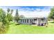 Relaxing backyard with a deck, screened patio, and a gazebo offering views of the manicured lawn and trees at 31636 Gladys Ln, Tavares, FL 32778