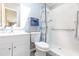 Well-lit bathroom with modern fixtures, featuring a walk-in shower and stylish blue and white shower curtain at 31636 Gladys Ln, Tavares, FL 32778