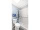 Modern bathroom with a walk-in shower featuring white tiling, blue accents, and sleek fixtures at 31636 Gladys Ln, Tavares, FL 32778