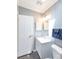 Bright bathroom features modern vanity, stone flooring, and white door at 31636 Gladys Ln, Tavares, FL 32778