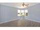 Bright bedroom with updated flooring, neutral walls, and a ceiling fan at 31636 Gladys Ln, Tavares, FL 32778