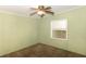 Empty bedroom with green walls, ceiling fan, and a large window, ready for personal touches at 31636 Gladys Ln, Tavares, FL 32778