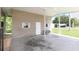 A view of the covered carport featuring neutral colored siding, painted trim, and a concrete floor, with a residential neighborhood visible at 31636 Gladys Ln, Tavares, FL 32778