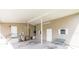 A view of the covered carport featuring neutral colored siding, painted trim, and a concrete floor and an adjacent grassy area at 31636 Gladys Ln, Tavares, FL 32778