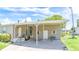 Exterior of home featuring covered parking, lush lawn, and mature landscaping at 31636 Gladys Ln, Tavares, FL 32778