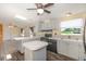 Charming kitchen features ample counter space, dark appliance suite, a skylight and gray cabinets at 31636 Gladys Ln, Tavares, FL 32778