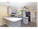 This kitchen offers gray cabinets, stainless steel appliances, and modern countertops and backsplash at 31636 Gladys Ln, Tavares, FL 32778