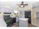 Charming kitchen features ample counter space, a dark appliance suite and gray cabinets at 31636 Gladys Ln, Tavares, FL 32778