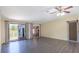 Open living area features wood floors, sliding doors to deck, and barn-style door at 31636 Gladys Ln, Tavares, FL 32778