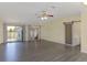 Large living room features wood floors, a sliding barn door, and sliding doors to the deck at 31636 Gladys Ln, Tavares, FL 32778