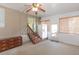 Enclosed sunroom featuring carpet, stairs, and bonus refrigerator at 31636 Gladys Ln, Tavares, FL 32778