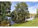 Waterfront view with private dock, lush greenery and serene waterfront at 31636 Gladys Ln, Tavares, FL 32778