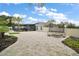Large backyard features a stone patio, screened-in pool, landscaping, and trampoline for outdoor fun at 318 Stone Castle Loop, Lady Lake, FL 32159