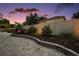 Well-maintained backyard with pavers, lush landscaping, and privacy fence at 318 Stone Castle Loop, Lady Lake, FL 32159