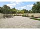 Spacious backyard with paved patio, trampoline, manicured landscaping, and privacy fence at 318 Stone Castle Loop, Lady Lake, FL 32159