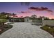 An expansive backyard featuring pavers, a trampoline, and lush landscaping, ideal for entertaining at 318 Stone Castle Loop, Lady Lake, FL 32159