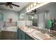 Bathroom with dual sinks, large mirror, soaking tub, and tiled floors at 318 Stone Castle Loop, Lady Lake, FL 32159