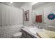 Bright bathroom features a single sink vanity and shower with a decorative giraffe art piece at 318 Stone Castle Loop, Lady Lake, FL 32159