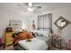 Cozy bedroom featuring a plush toy, and neutral decor with a ceiling fan at 318 Stone Castle Loop, Lady Lake, FL 32159