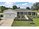 Beautiful one-story home with a charming front porch and well-kept lawn at 318 Stone Castle Loop, Lady Lake, FL 32159