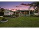 Charming single-story home with a well-manicured lawn and inviting front porch, perfect for relaxing evenings at 318 Stone Castle Loop, Lady Lake, FL 32159