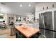 Kitchen featuring stainless steel appliances, an island, lots of light and access to living areas at 318 Stone Castle Loop, Lady Lake, FL 32159