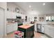 Kitchen boasts stainless steel appliances, a center island, and open floorplan at 318 Stone Castle Loop, Lady Lake, FL 32159