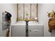 Bright laundry room features a white side-by-side washer and dryer and floral wallpaper at 318 Stone Castle Loop, Lady Lake, FL 32159